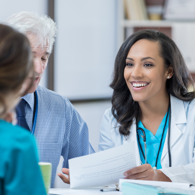 Smiling healthcare professional in a meeting, representing mission-driven healthcare jobs and teamwork in the medical field