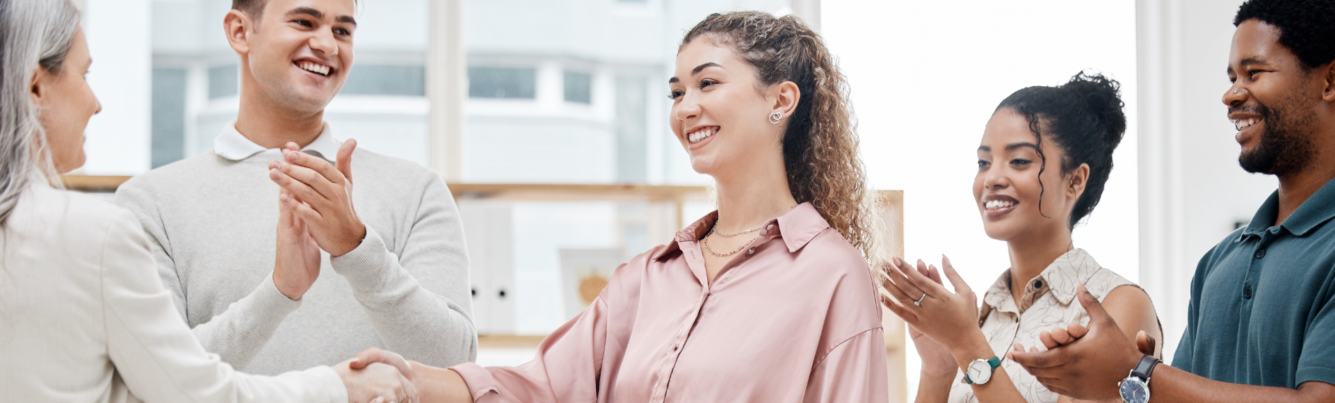 Team members congratulating a new hire, representing mission-driven startups hiring in October 2024